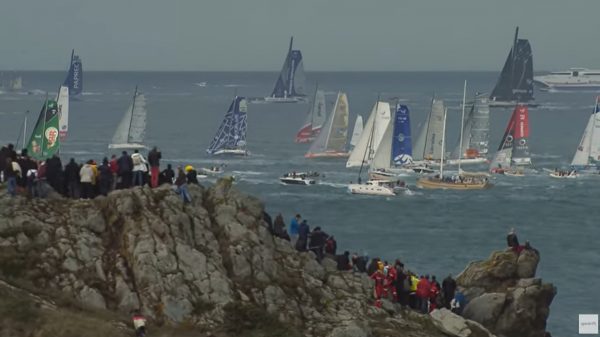 Spectators watch the start of the Route du Rhum from the coast.