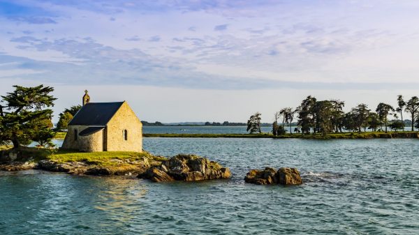 Atemberaubender Blick auf die Île Boedic und ihre berühmte Kapelle bei Sonnenuntergang